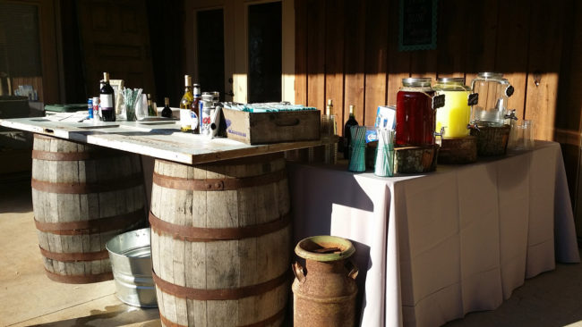 A bar setup with wooden barrels