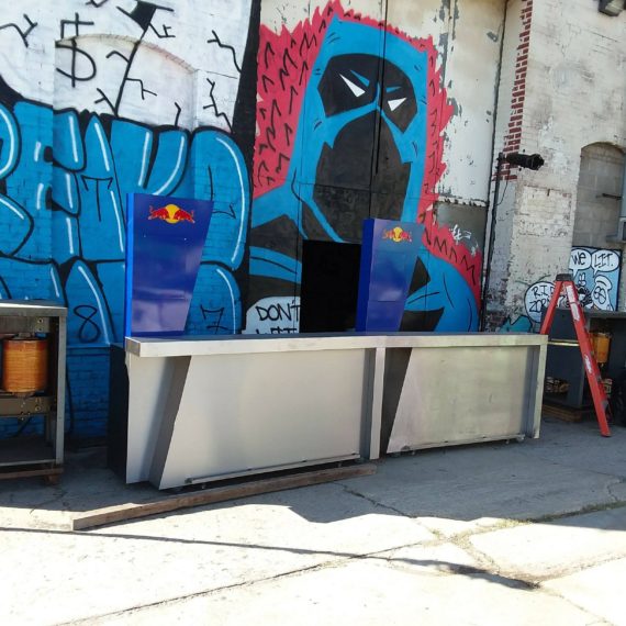 A street scene with graffiti and a bench.