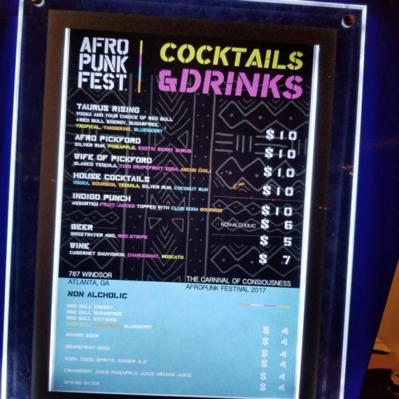 A menu board with cocktails and drinks written on it.