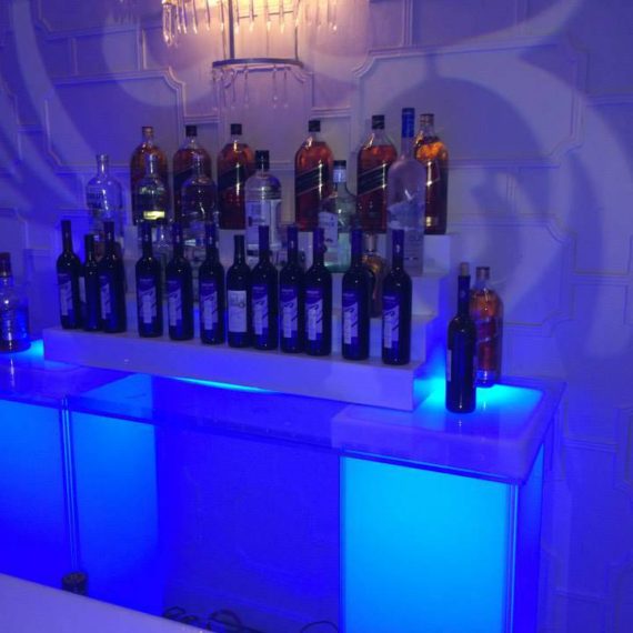 A bar with many bottles of alcohol on top